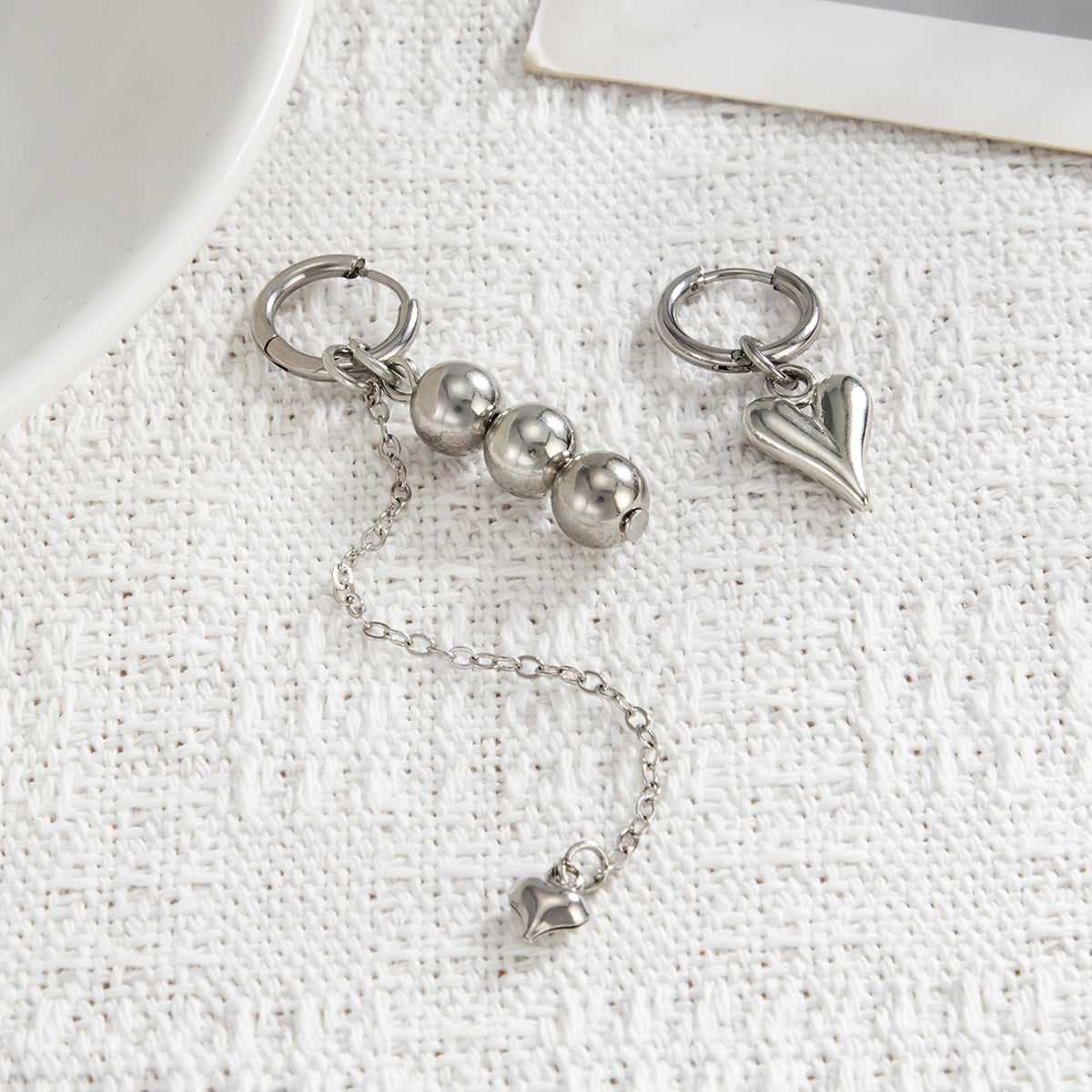 Silvertone Mismatching Beaded Tassel Heart Dangle Earrings