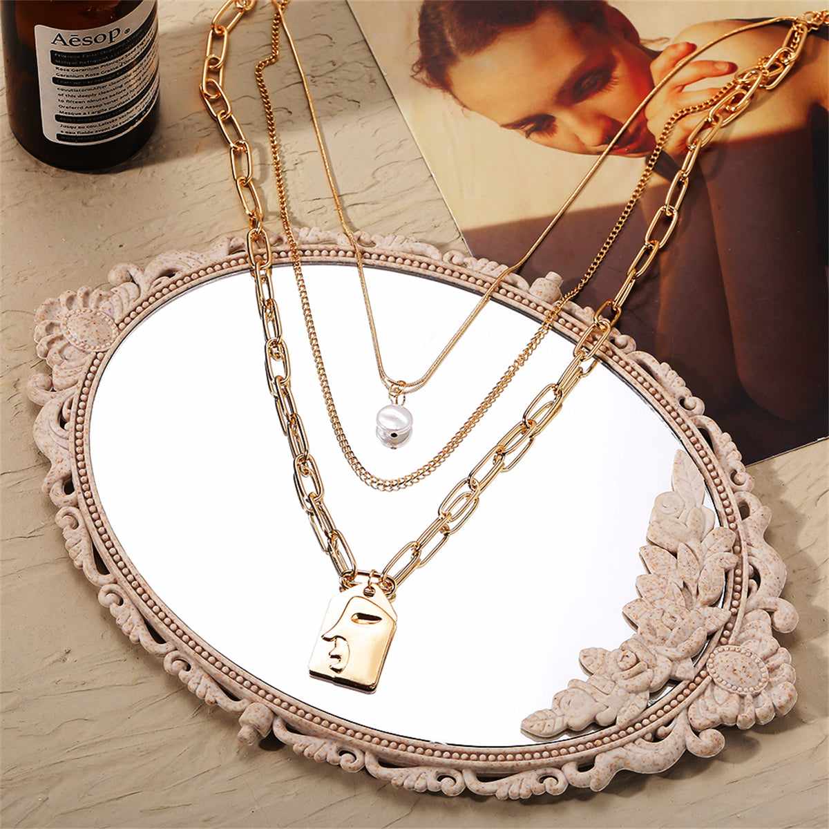 Pearl & Goldtone Embossed Face Pendant Necklace