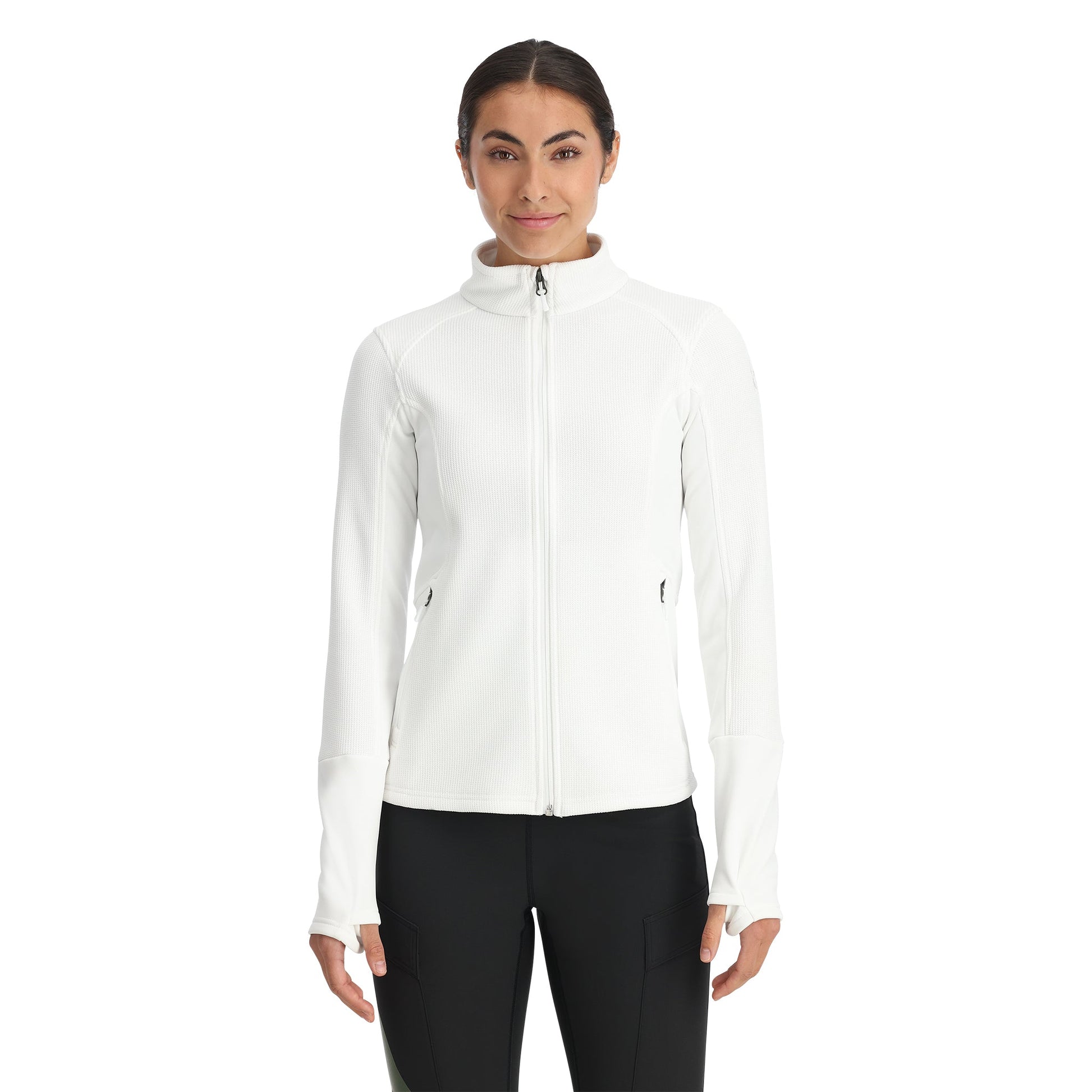A woman wearing a white full zip Activewear sweatshirt with thumbholes, paired with black pants.