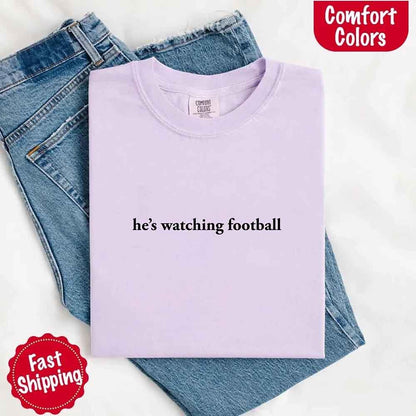 He’s Watching Football Tee - Comfort Colors Funny Shirt for Her