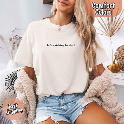 He’s Watching Football Tee - Comfort Colors Funny Shirt for Her