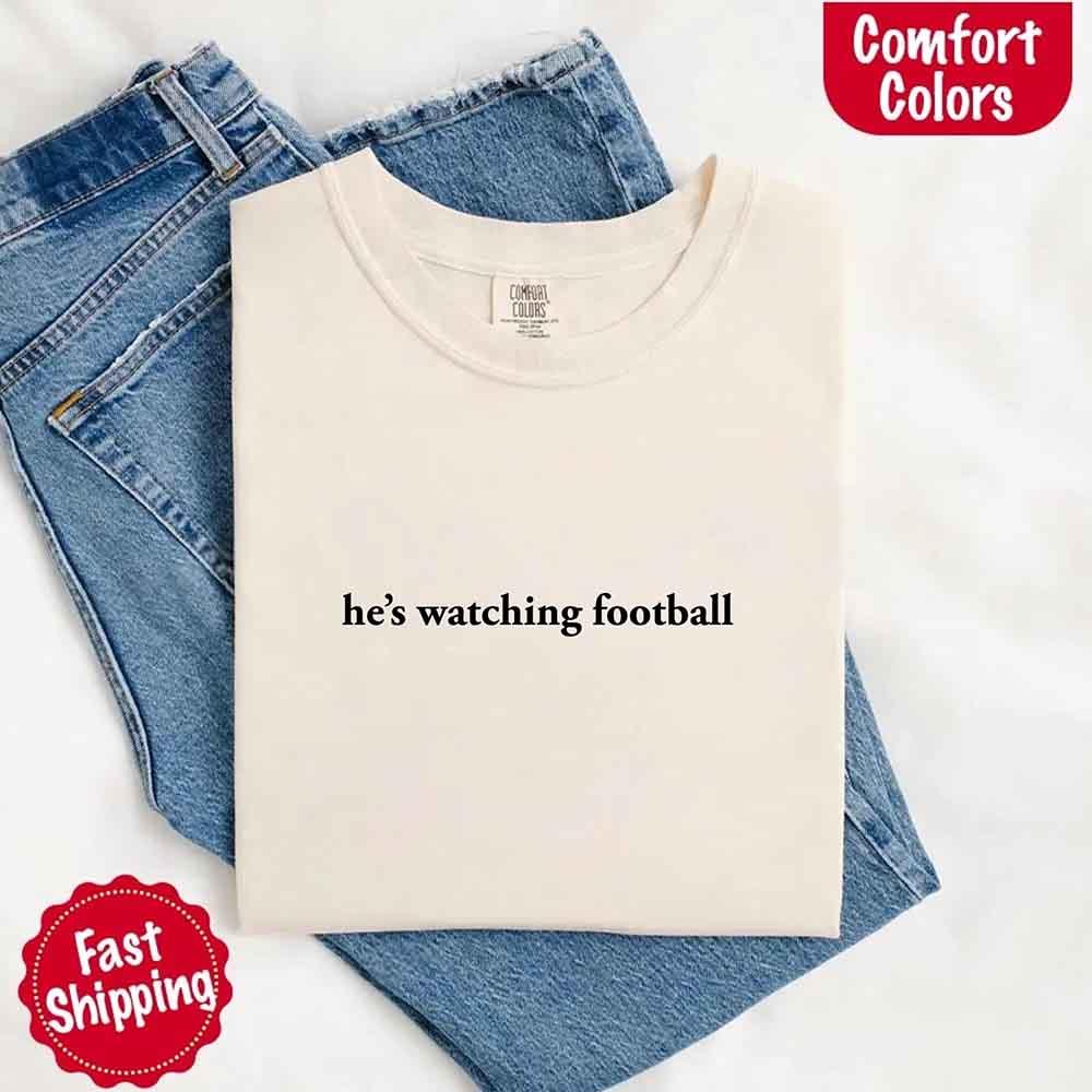 He’s Watching Football Tee - Comfort Colors Funny Shirt for Her