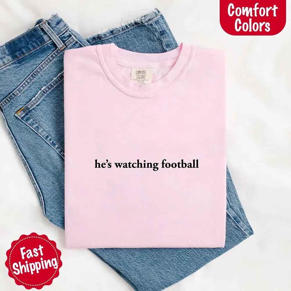 He’s Watching Football Tee - Comfort Colors Funny Shirt for Her