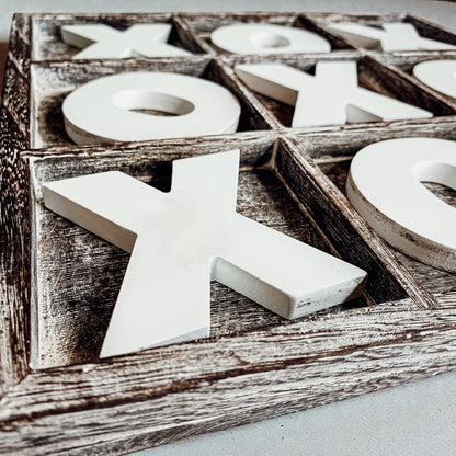 rustic distressed wood game board home decor
modern farmhouse coffee table decor with game
decorative wooden x and o pieces on game board
handmade USA wooden tic tac toe board on shelf
living room styling with tic tac toe game decor