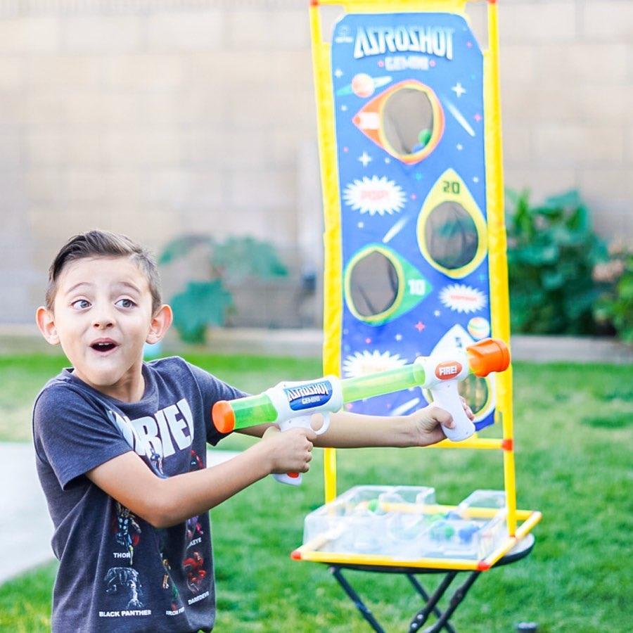 White, blue dart gun and green, blue balls-