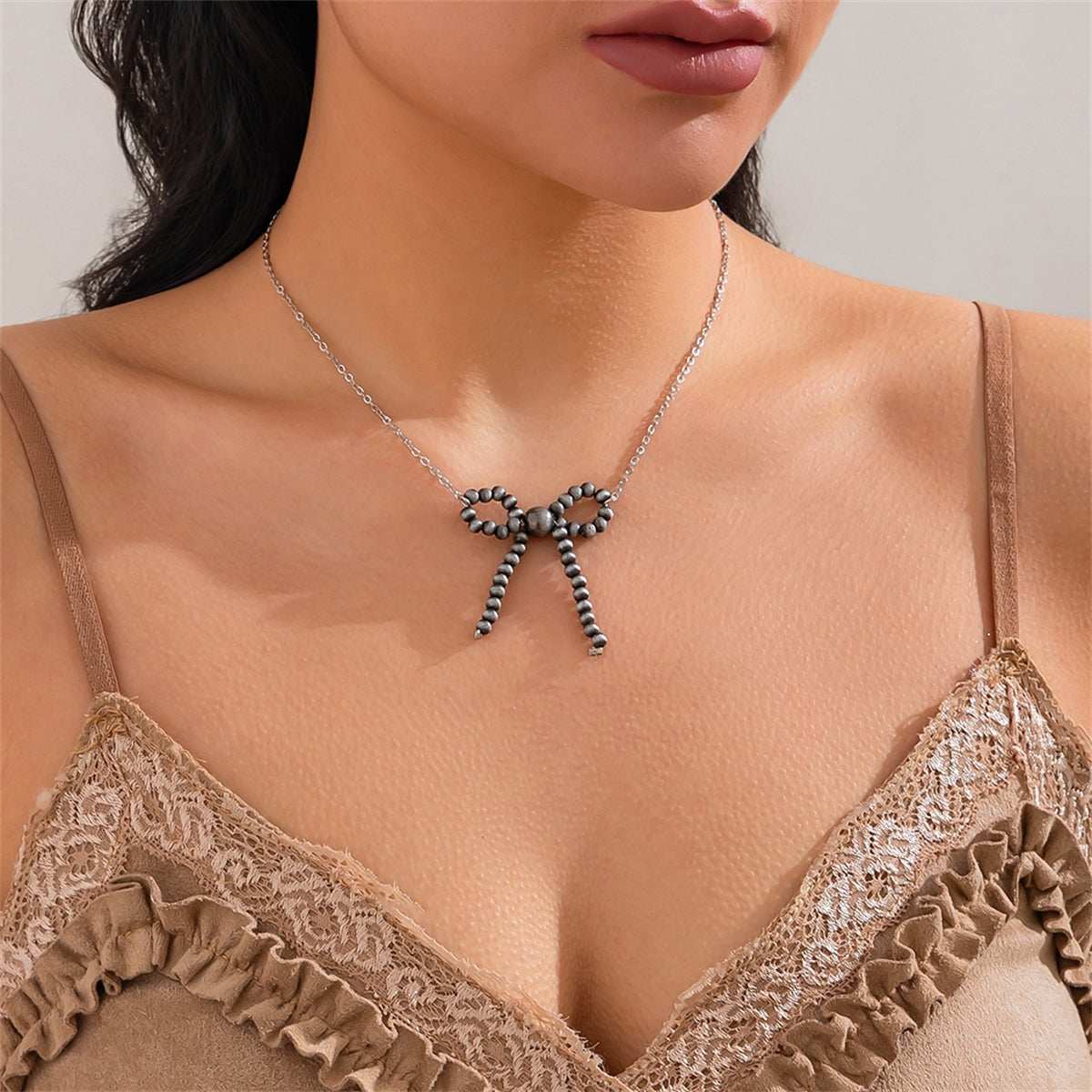 Dark Resin & Silvertone Bow Pendant Necklace