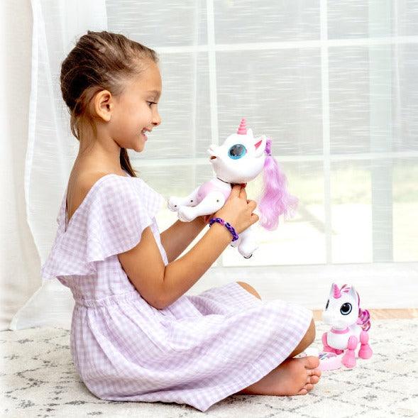 Pink/White robot unicorn, white remote, and , pink and black food-