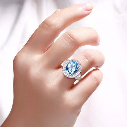 4 Ct Oval Swiss Blue Topaz and Lab Diamond Silver Halo Statement Ring
