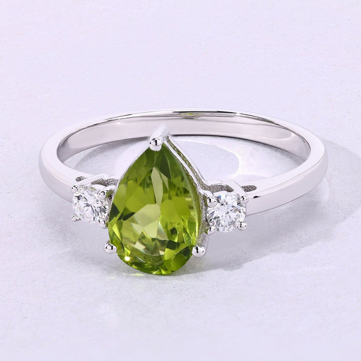 1.10 Ct Pear Green Peridot and Lab Diamond Prong Silver Three Stone Ring