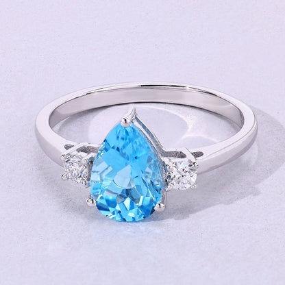 1.30 Ct Pear Swiss Blue Topaz and Lab Diamond Prong Silver Three Stone Ring