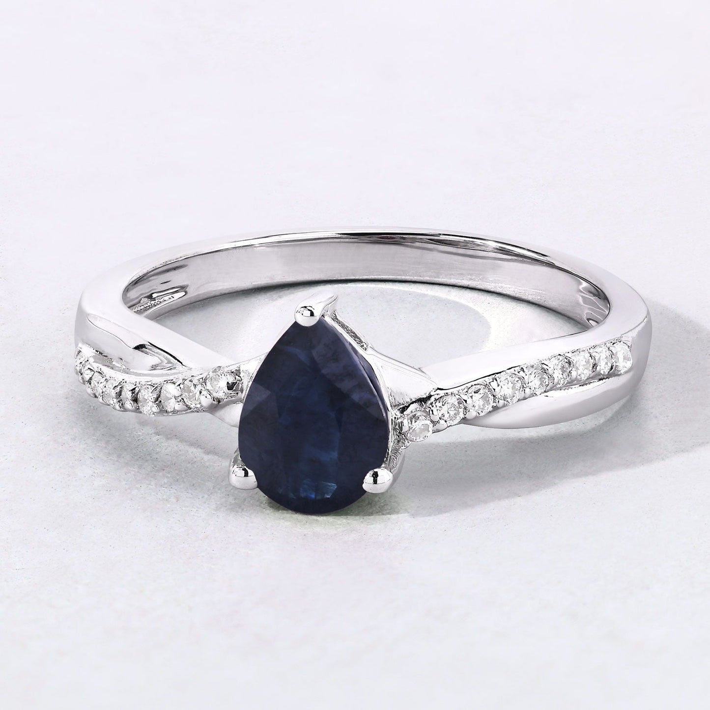 0.80 Ct Pear Blue Sapphire and Lab Diamond Prong Silver Pave Crossover Ring