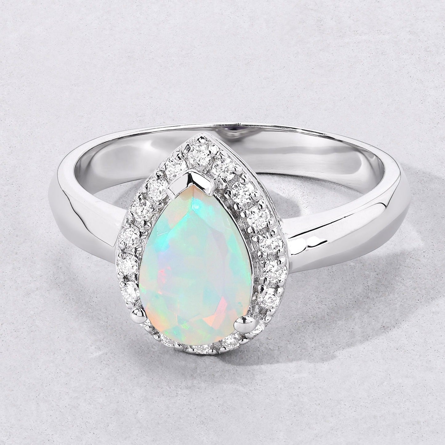 0.90 Ct Teardrop White Ethiopian Opal and Lab Diamond Prong Silver Halo Ring