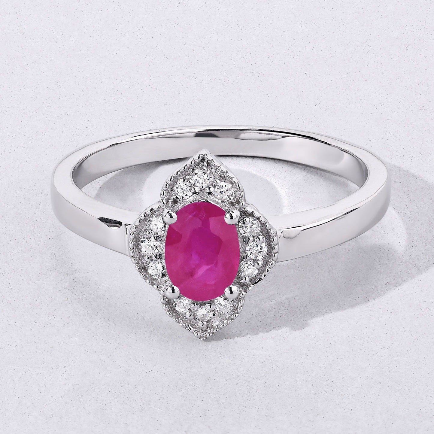 0.52 Ct Oval Pink Mozambique Ruby & Lab Diamond Prong Silver Floral Halo Ring