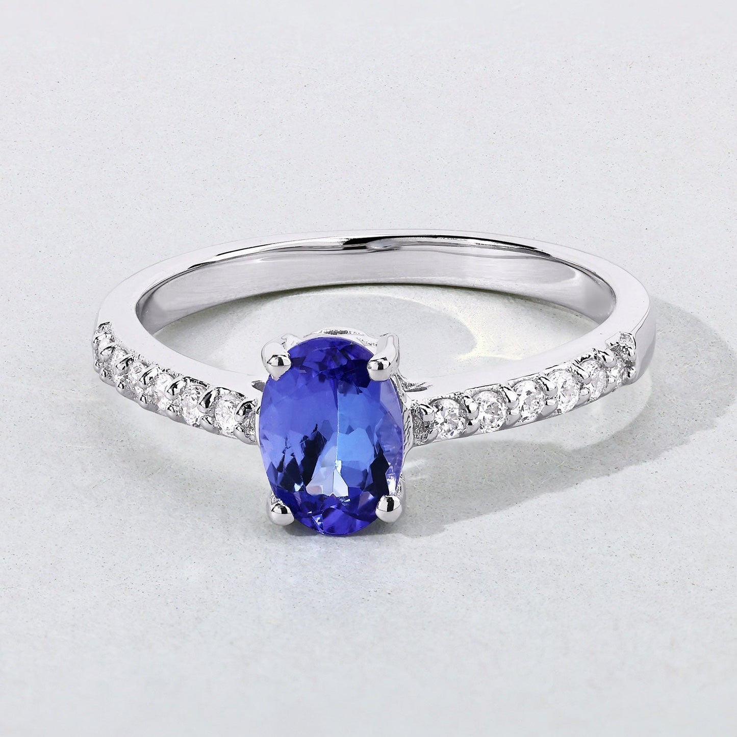 0.75 Ct Oval Violet Tanzanite and Lab Diamond Prong Silver Pave Band Ring