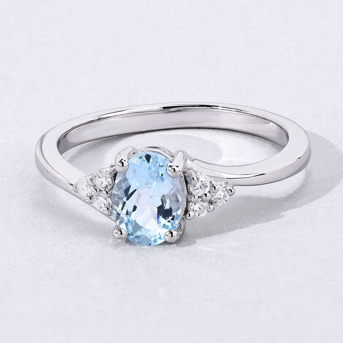0.60 Ct Oval Blue Aquamarine and Lab Diamond Prong Sterling Silver Bypass Ring