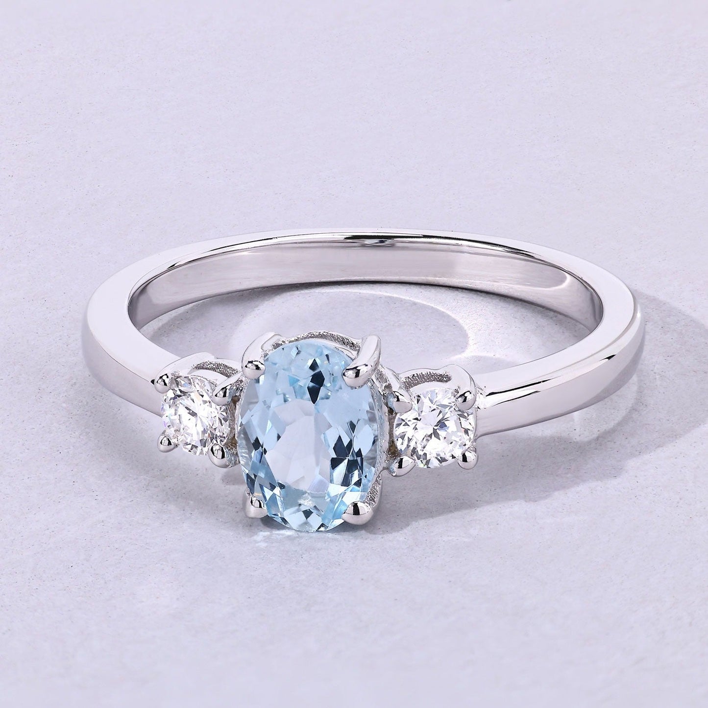0.60 Ct Oval Blue Aquamarine and Lab Diamond Prong Silver Three Stone Ring