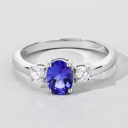 0.75 Ct Oval Violet Tanzanite and Lab Diamond Prong Silver Three Stone Ring