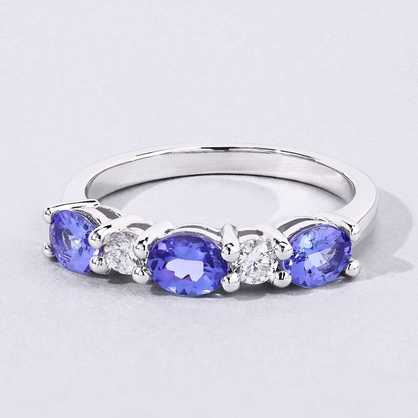 0.99 Ct Oval Violet Tanzanite and Lab Grown Diamond Prong Silver Five Stone Ring