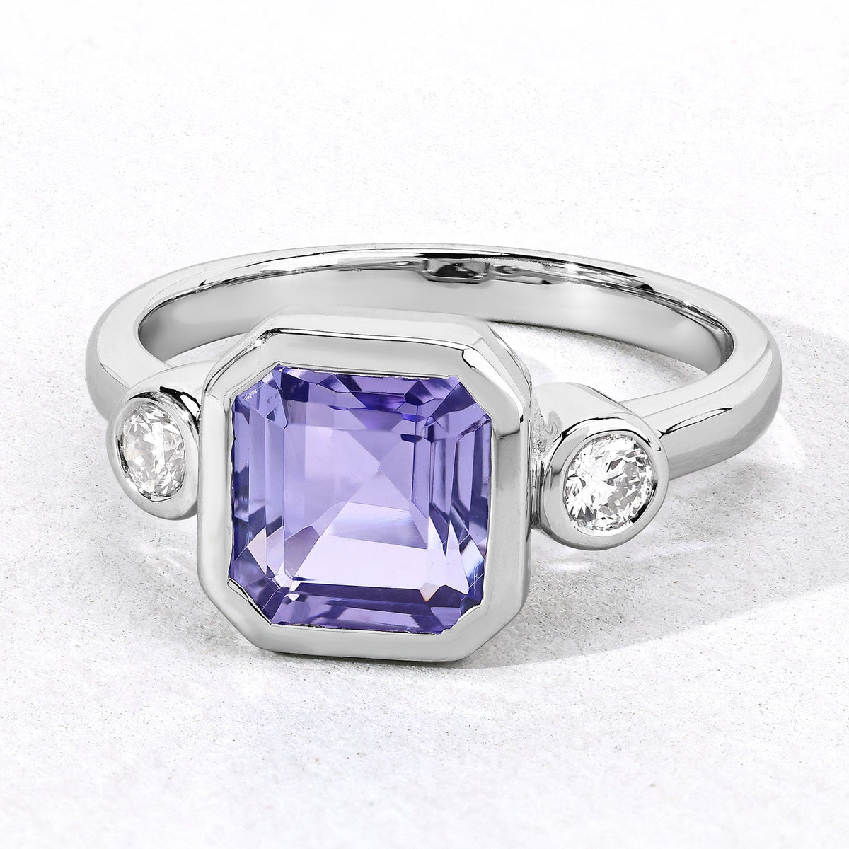 3.49 Cttw Octagon Violet Tanzanite and Lab Diamond Bezel Rhodium over Silver 3-Stone Ring